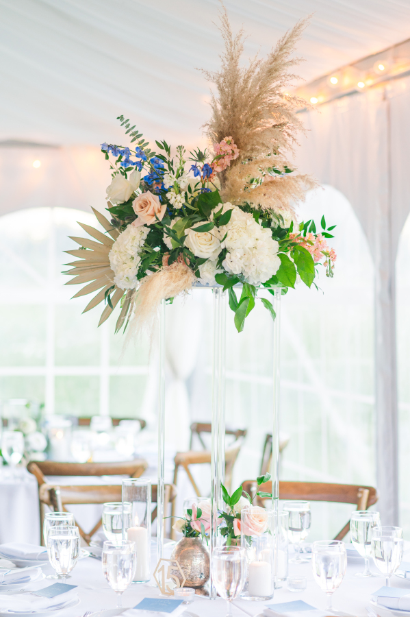 Details of a tall boho style wedding reception centerpiece