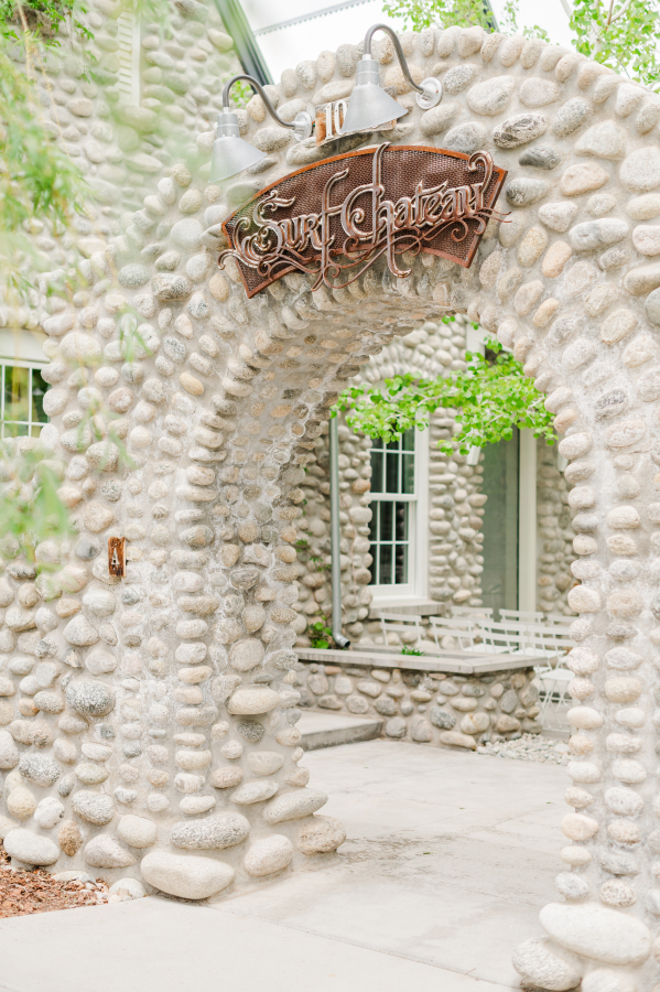 Details of a stone archway with a venue sign