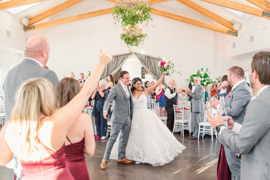 Newlyweds enter their reception to big cheers during their the manor house wedding