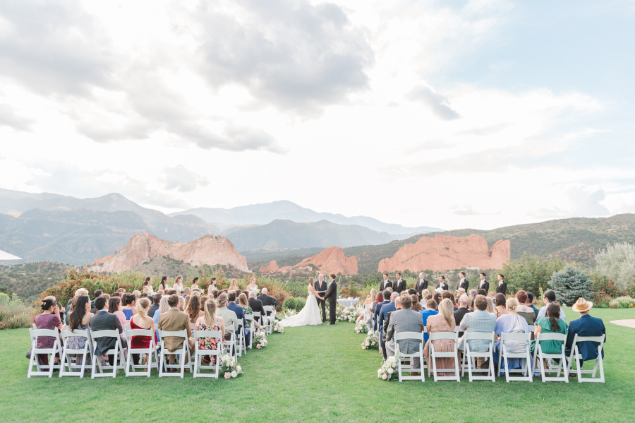 A wedding ceremony takes place in the lawn of the Colorado Springs wedding venue at Garden of the gods