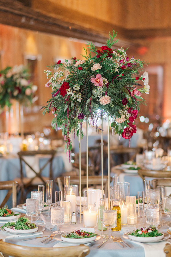 Details of a wedding reception set up with tall colorful centerpiece