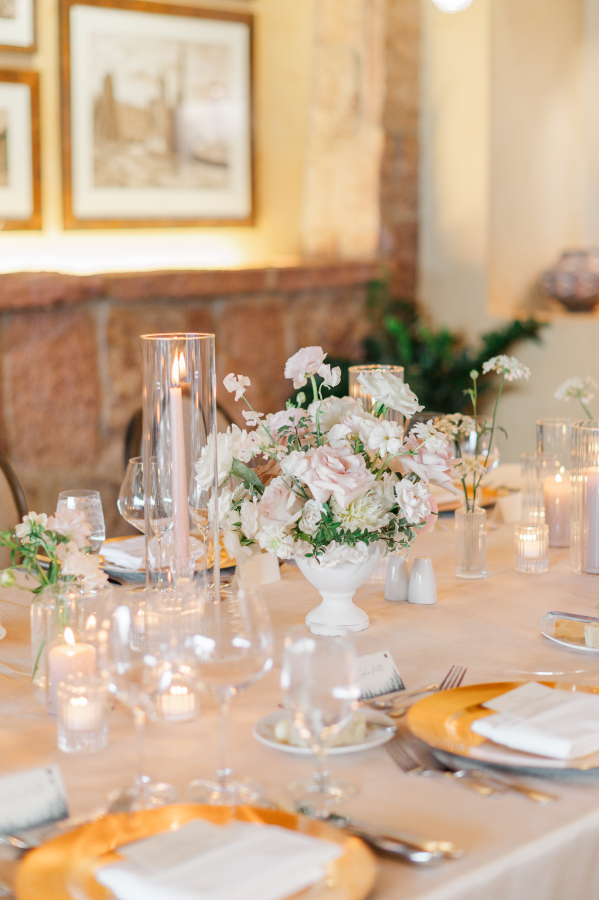 Details of a wedding reception table with white flower centerpiece