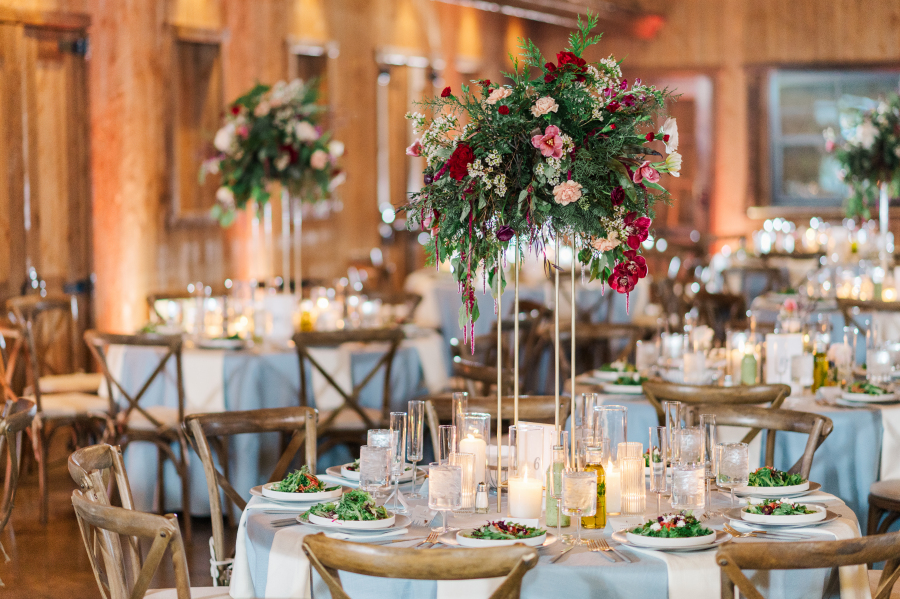 Details of a tall flower table centerpiece at a spruce mountain ranch wedding reception
