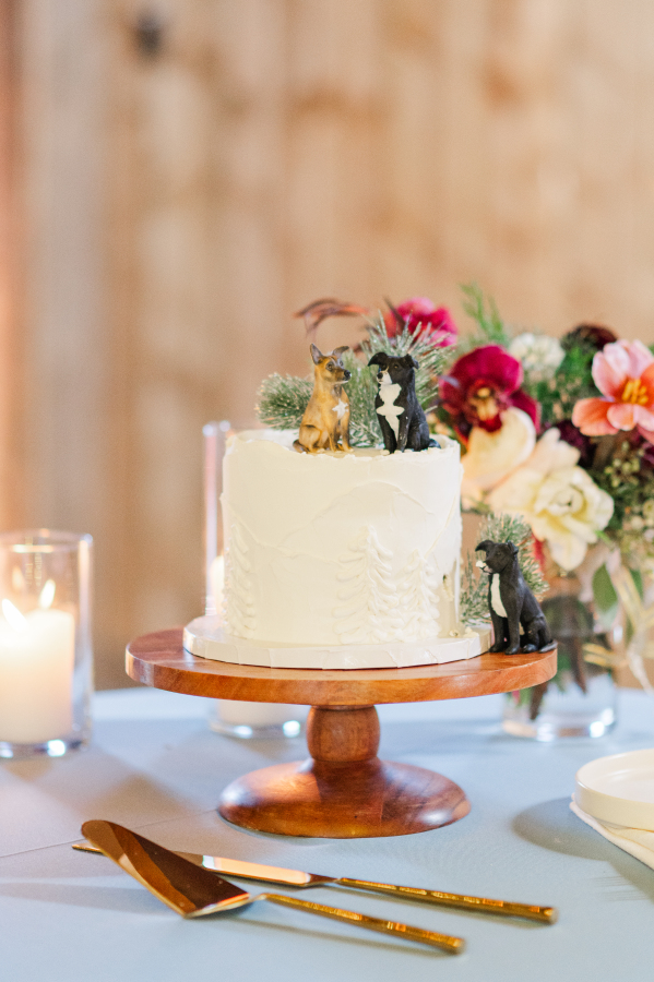 Details of a one tier wedding cake with three dog figurines