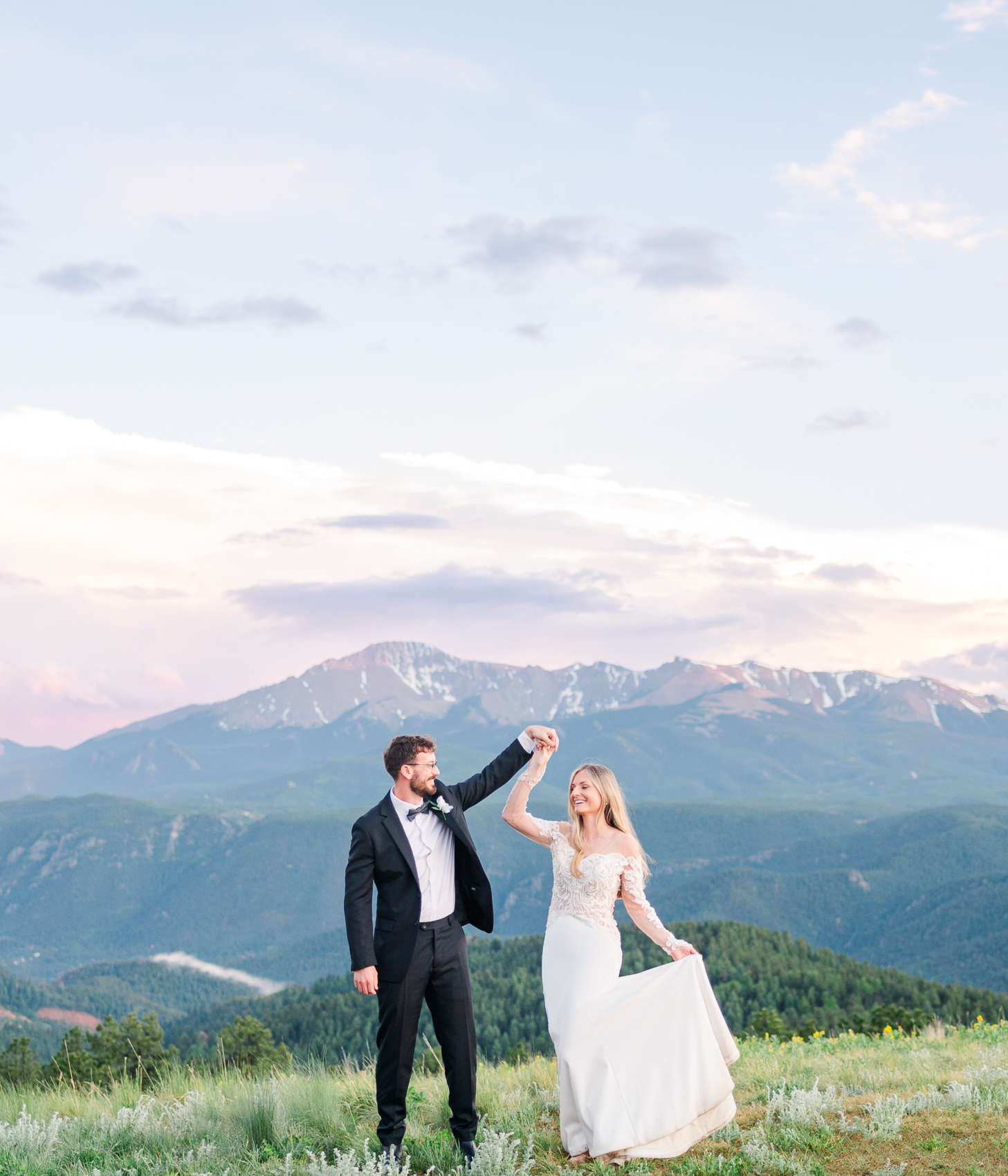 A bride and groom dance on top a mountain overlook at Northstar Gatherings wedding venue in Colorado