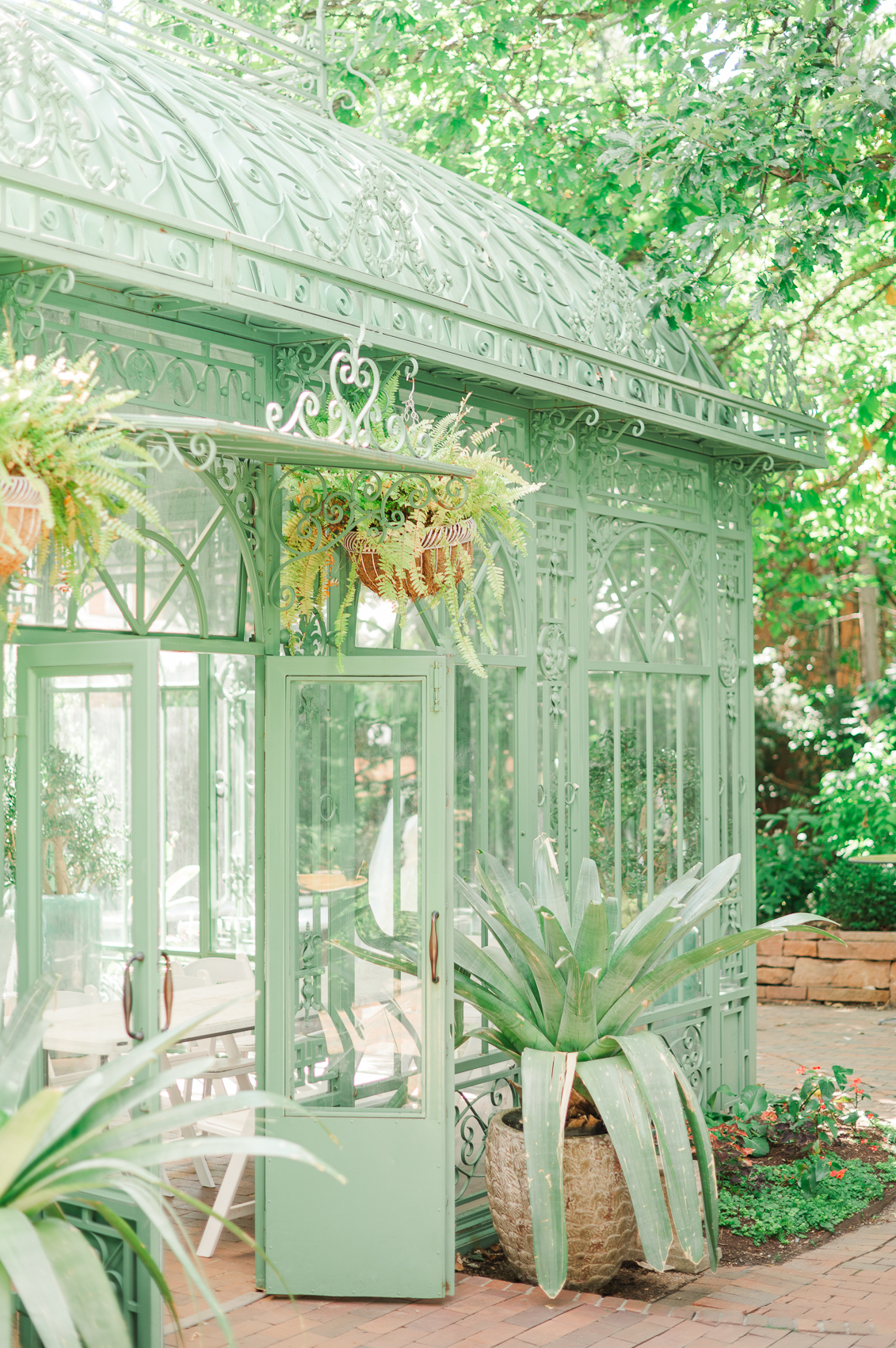 Details of a greenhouse reception space set up with vibrant flowers